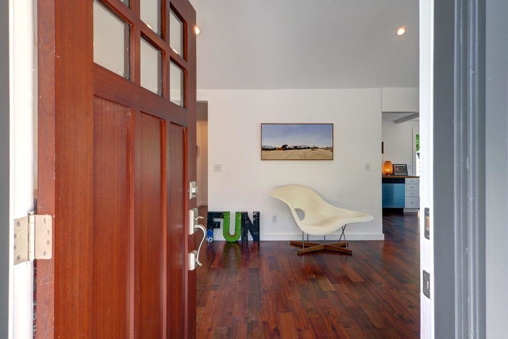 Inspiration for a mid-sized contemporary medium tone wood floor entryway remodel in Los Angeles with white walls and a medium wood front door