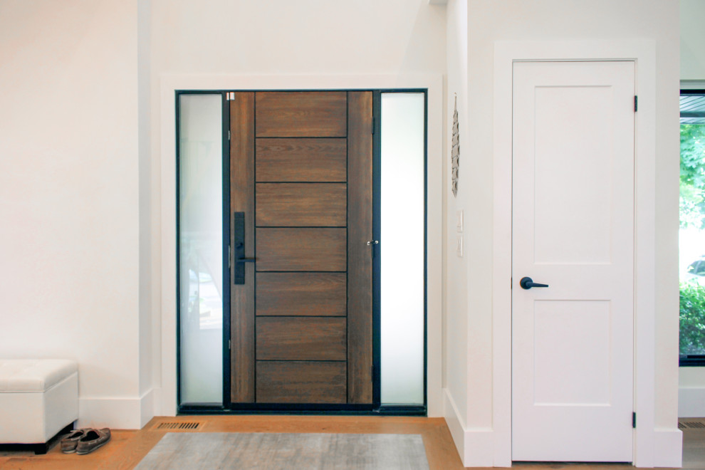 Inspiration for a medium sized contemporary foyer in Toronto with white walls, light hardwood flooring, a single front door and a medium wood front door.