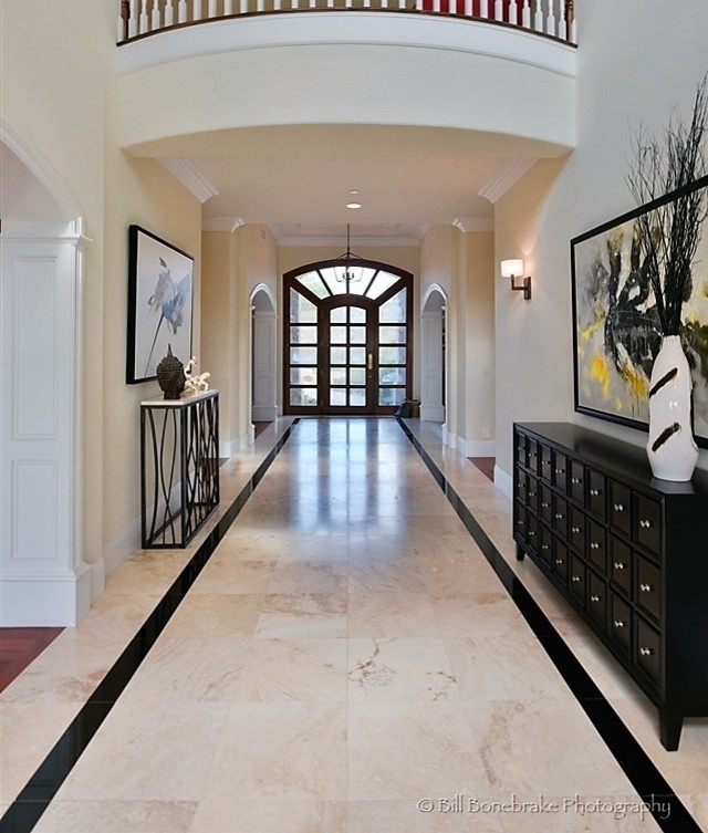 Example of a huge transitional marble floor entryway design in Austin with beige walls and a dark wood front door