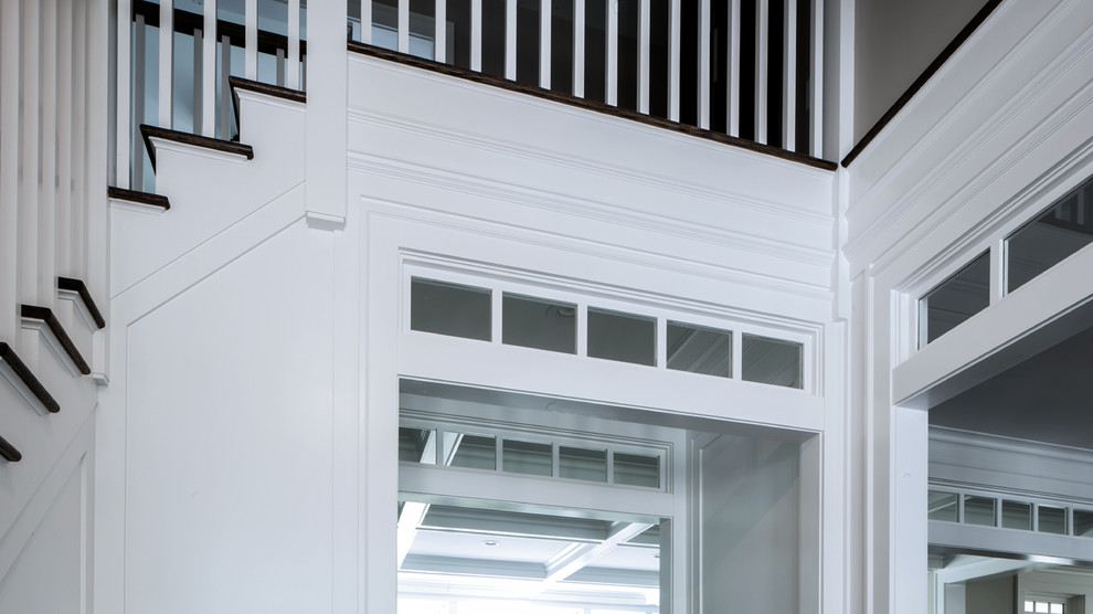 Imagen de distribuidor minimalista de tamaño medio con paredes beige, suelo de madera oscura, puerta simple y puerta blanca