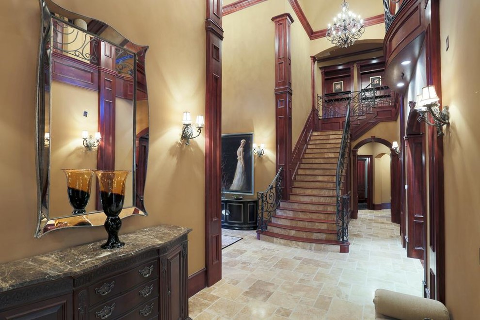 Inspiration for a large timeless ceramic tile entry hall remodel in Houston with beige walls and a glass front door