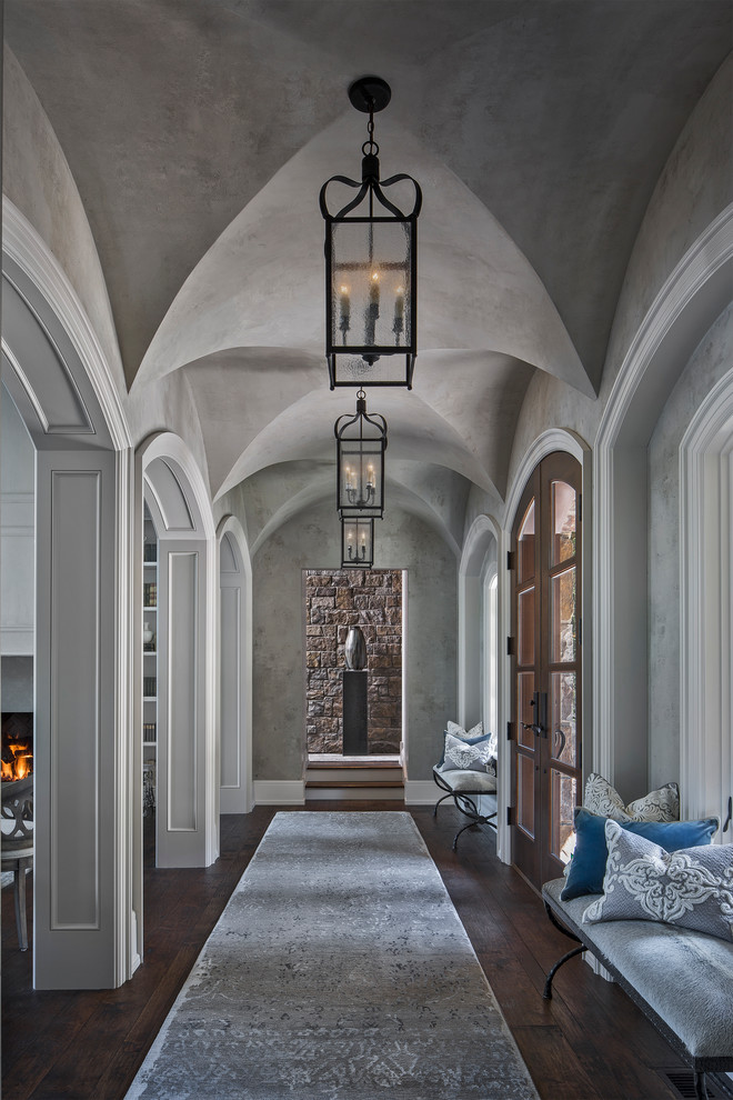 Entrance in Detroit with grey walls, dark hardwood flooring, a double front door and a glass front door.