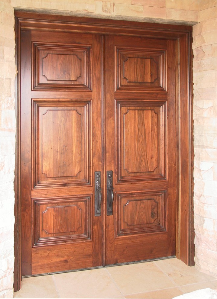 Entryway - large traditional travertine floor entryway idea in Phoenix with beige walls and a dark wood front door