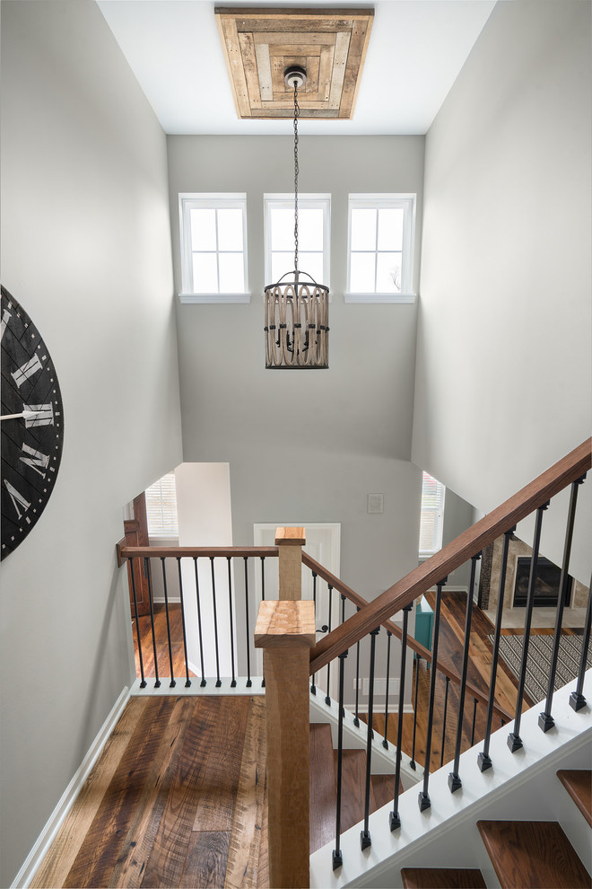 Photo of an expansive traditional foyer in Columbus with grey walls, medium hardwood flooring, a single front door, a medium wood front door and brown floors.