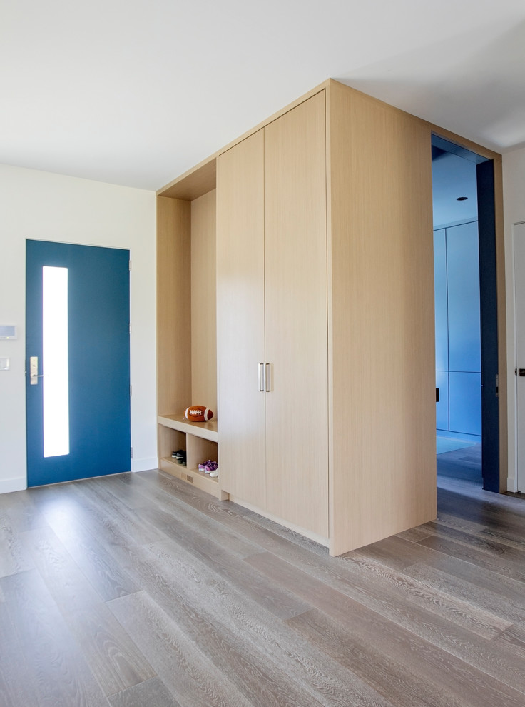Idéer för mellanstora funkis foajéer, med vita väggar, mellanmörkt trägolv, en enkeldörr, en blå dörr och grått golv