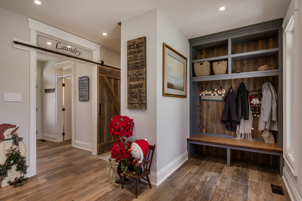 Photo of a small classic boot room in Toronto with grey walls, medium hardwood flooring and brown floors.