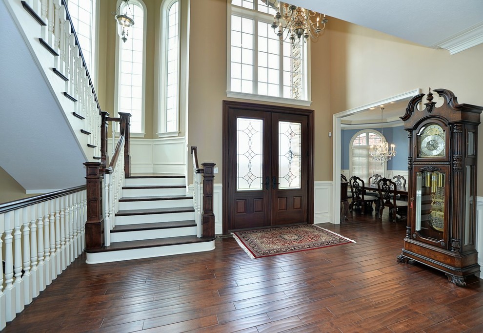 Medium sized traditional foyer in Other with beige walls, dark hardwood flooring, a double front door and a dark wood front door.