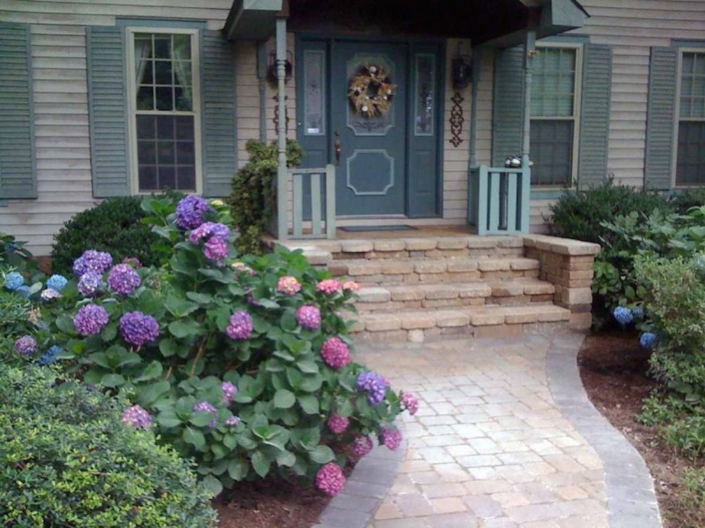 Example of a classic entryway design in Richmond with beige walls and a green front door
