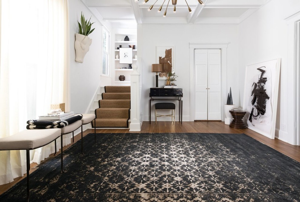 Example of a mid-sized trendy dark wood floor foyer design in Orange County with white walls