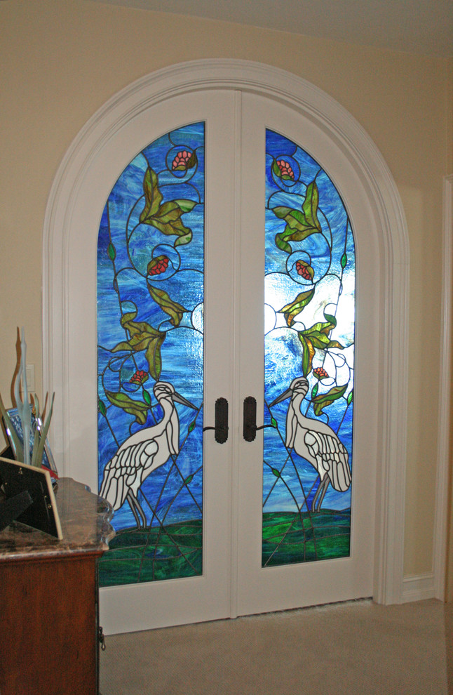 This is an example of a medium sized classic front door in New York with beige walls, carpet, a double front door and a glass front door.