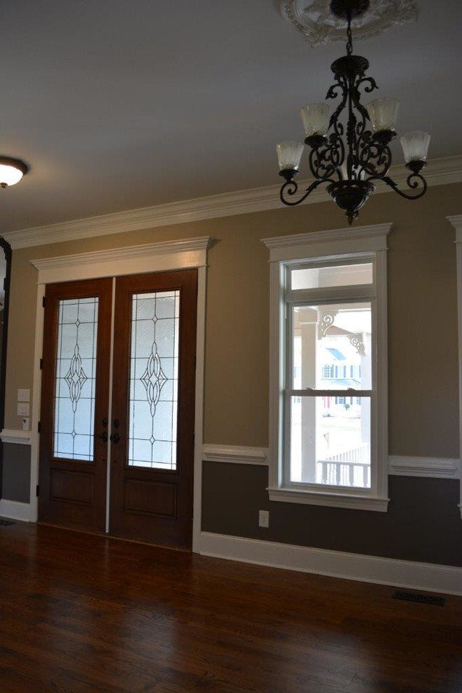 Стильный дизайн: узкая прихожая среднего размера в классическом стиле с серыми стенами, паркетным полом среднего тона, двустворчатой входной дверью, стеклянной входной дверью и коричневым полом - последний тренд
