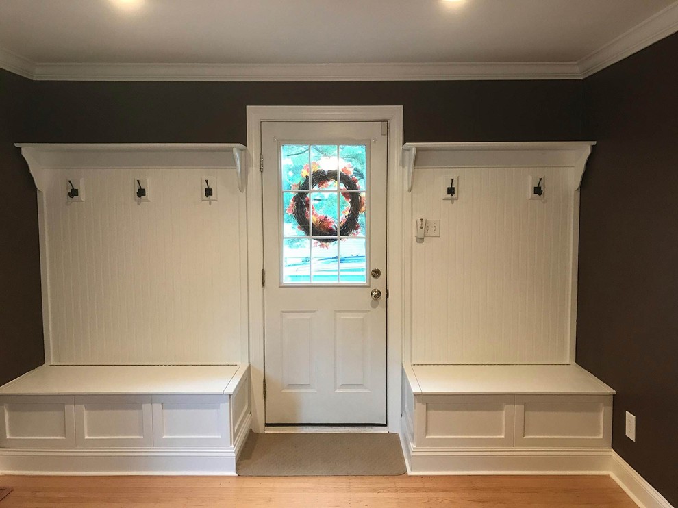 Photo of a large traditional boot room in Philadelphia with brown walls, medium hardwood flooring, a single front door, a white front door and brown floors.