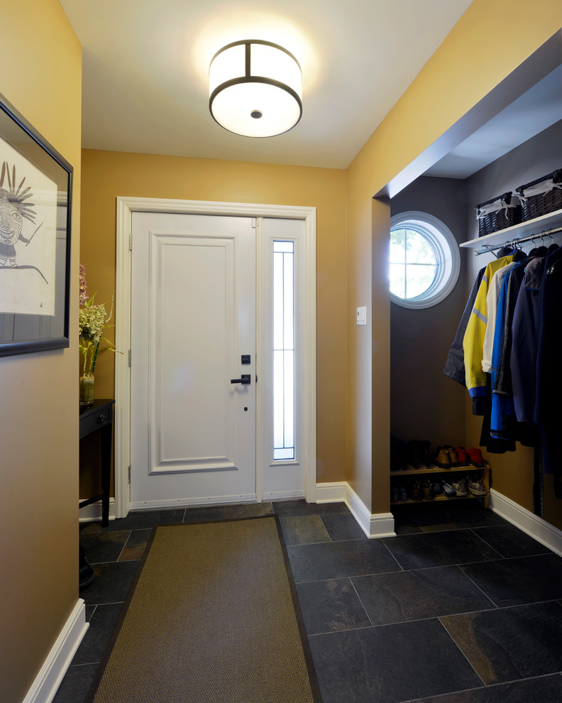 Inspiration for a small timeless slate floor entryway remodel in Ottawa with yellow walls and a white front door