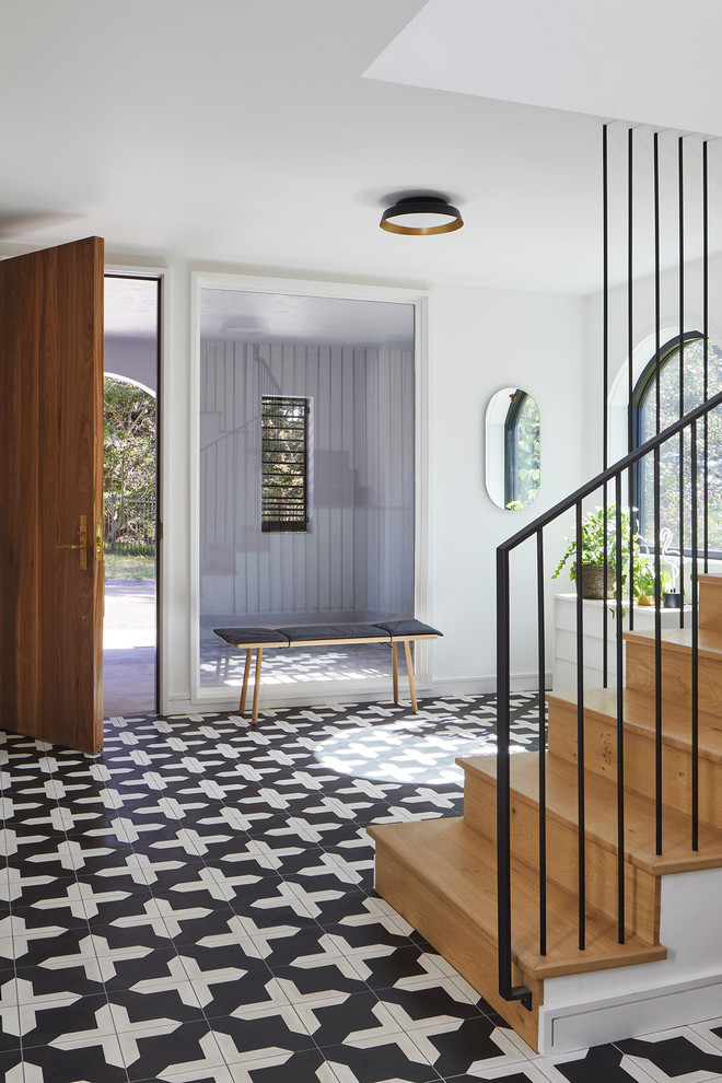 Medium sized contemporary foyer in San Francisco with white walls, a single front door, a medium wood front door, multi-coloured floors and ceramic flooring.