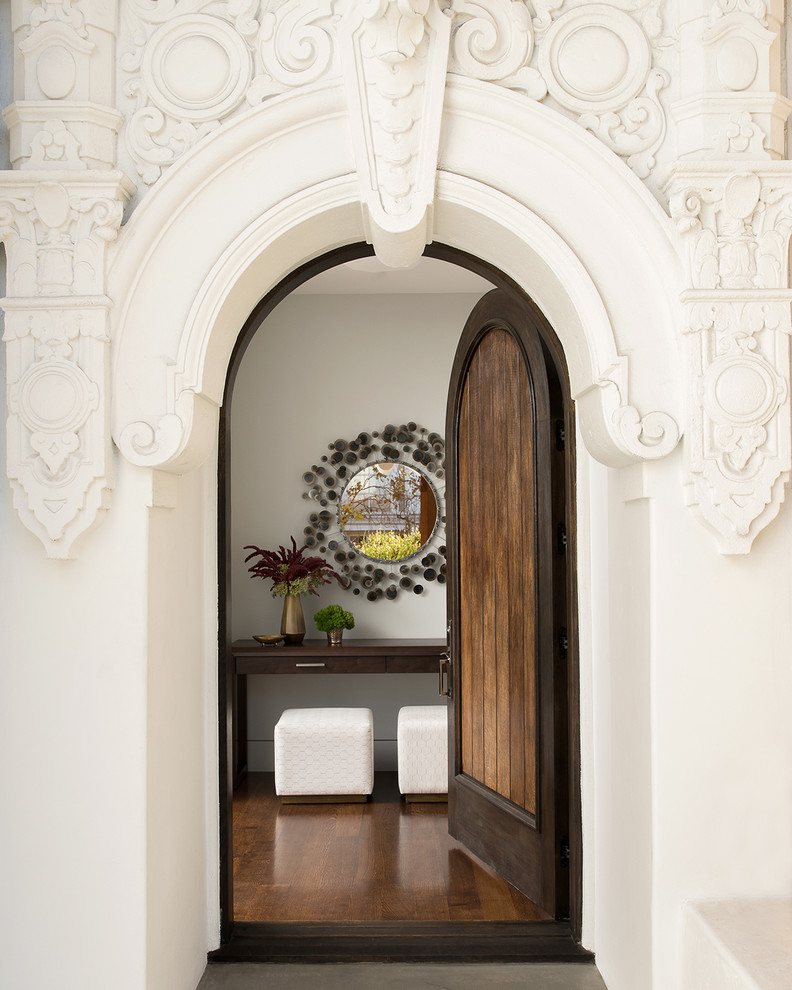 Example of a tuscan entryway design in San Francisco with a medium wood front door