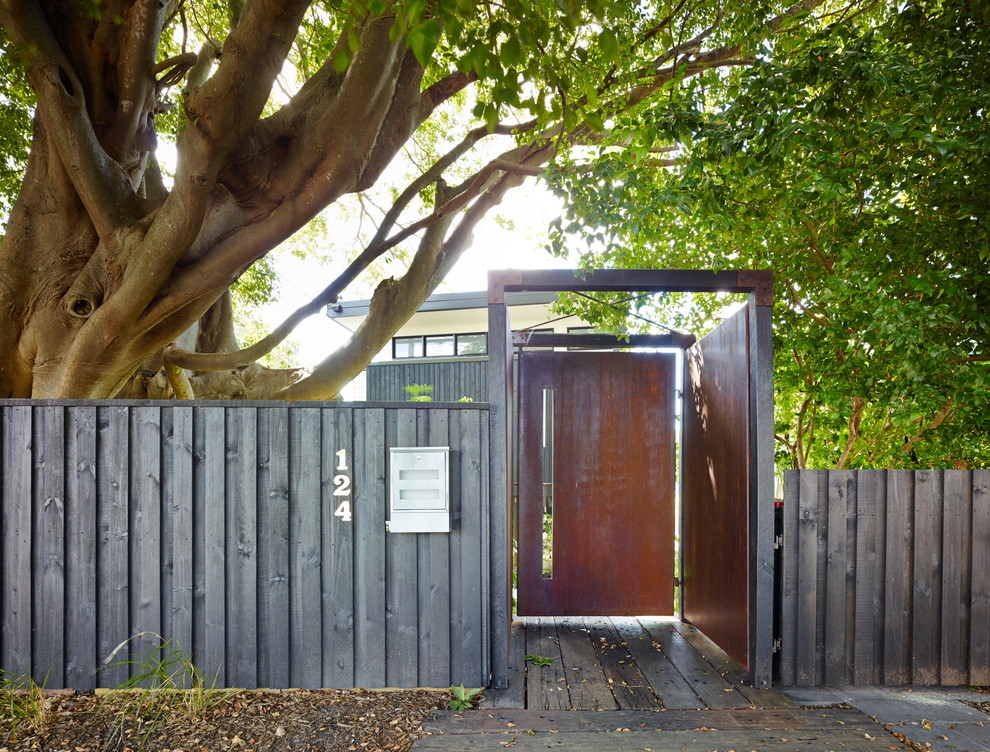 Contemporary entrance in Brisbane with a metal front door.