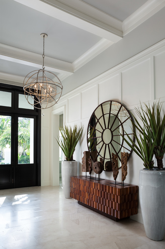 This is an example of a classic foyer in Miami with grey walls and beige floors.