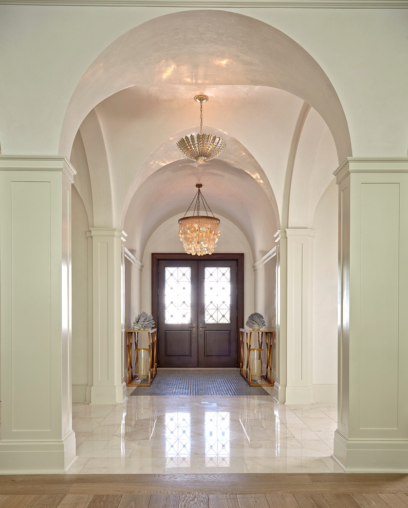 Design ideas for a traditional foyer in Miami with white walls, a double front door and a dark wood front door.
