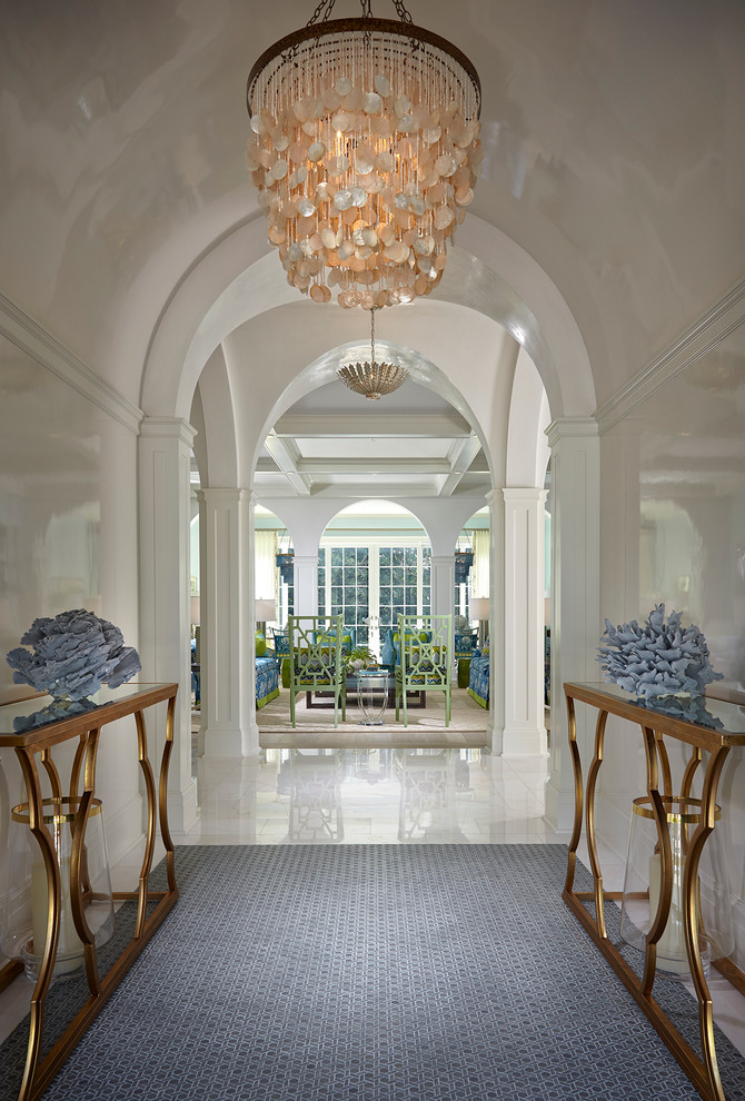 Design ideas for a traditional foyer in Miami with white walls and a dark wood front door.