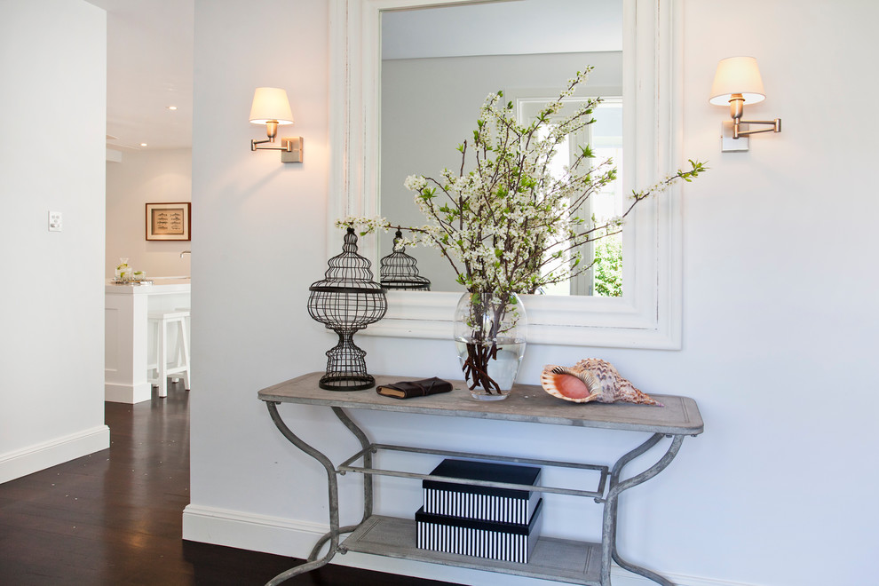 Inspiration for a beach style entrance in Sydney with white walls and dark hardwood flooring.