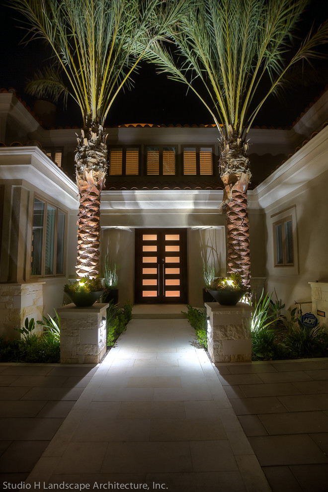 This is an example of a medium sized contemporary front door in Orange County with beige walls, limestone flooring, a double front door and a dark wood front door.