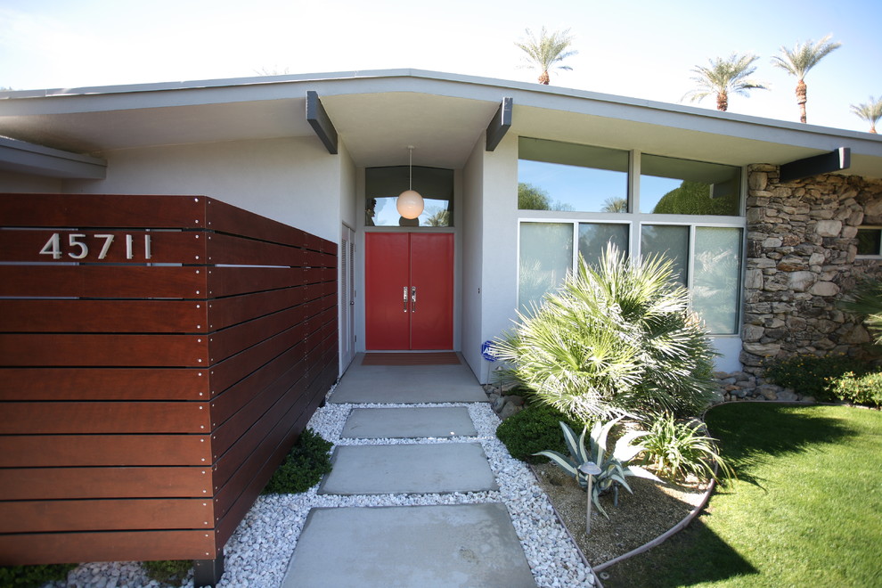 Photo of a retro entrance in Orange County with a double front door and a red front door.
