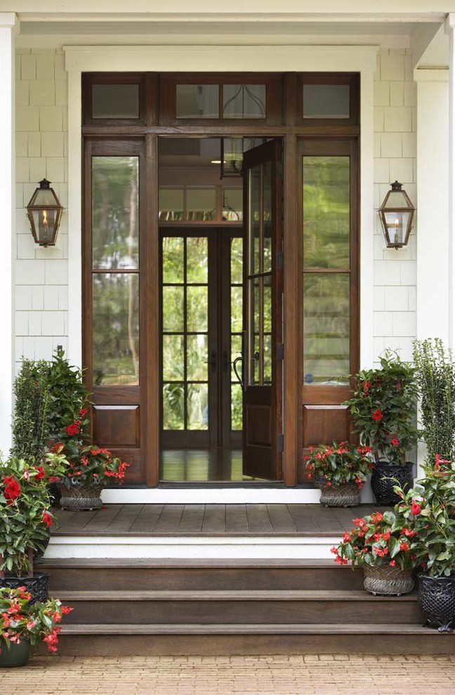 Large elegant entryway photo in Charleston with a dark wood front door