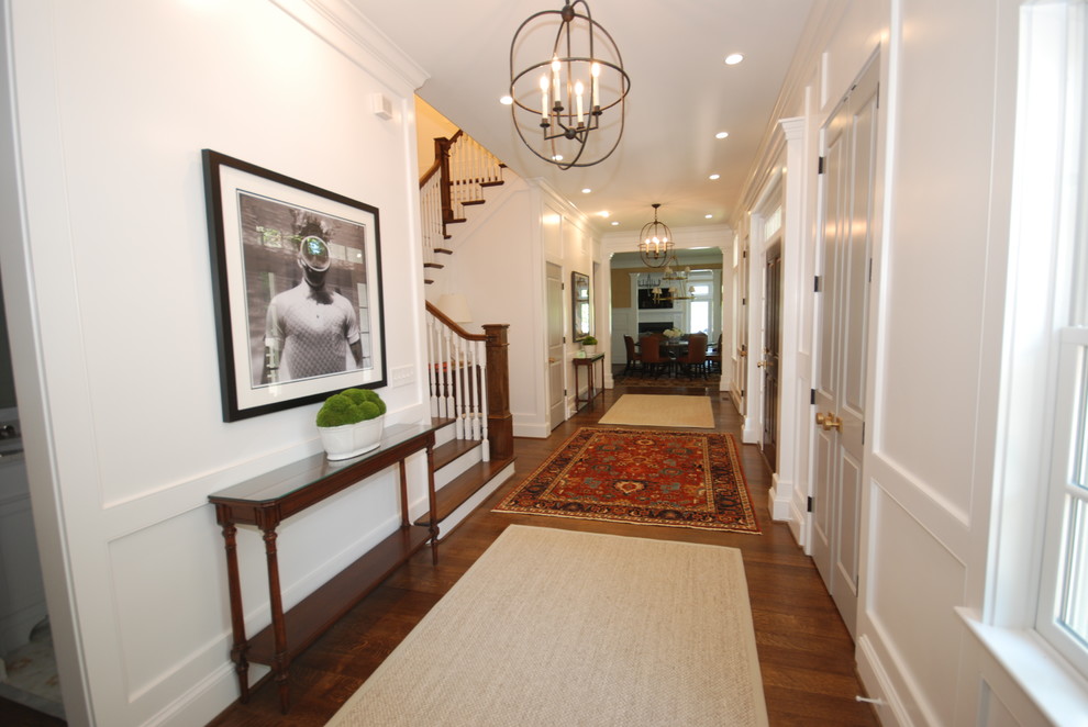 Inspiration for a large transitional dark wood floor and brown floor entryway remodel in DC Metro with white walls and a dark wood front door