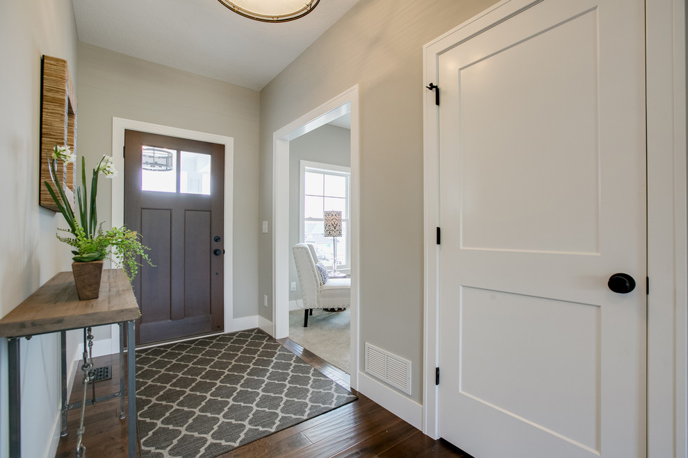 Example of a small cottage dark wood floor entryway design in Minneapolis with gray walls and a dark wood front door
