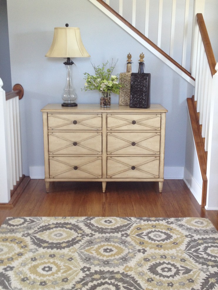 Inspiration for a large cottage medium tone wood floor and brown floor entryway remodel in Grand Rapids with blue walls