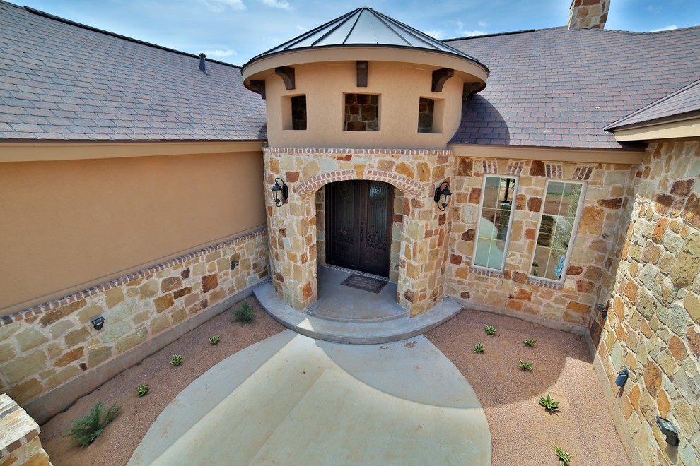Example of a mid-sized tuscan concrete floor entryway design in Dallas with metallic walls and a metal front door