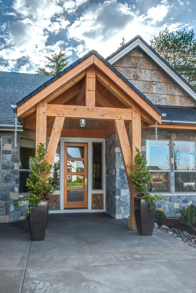 Example of a mid-sized mountain style concrete floor entryway design in Portland with gray walls and a medium wood front door