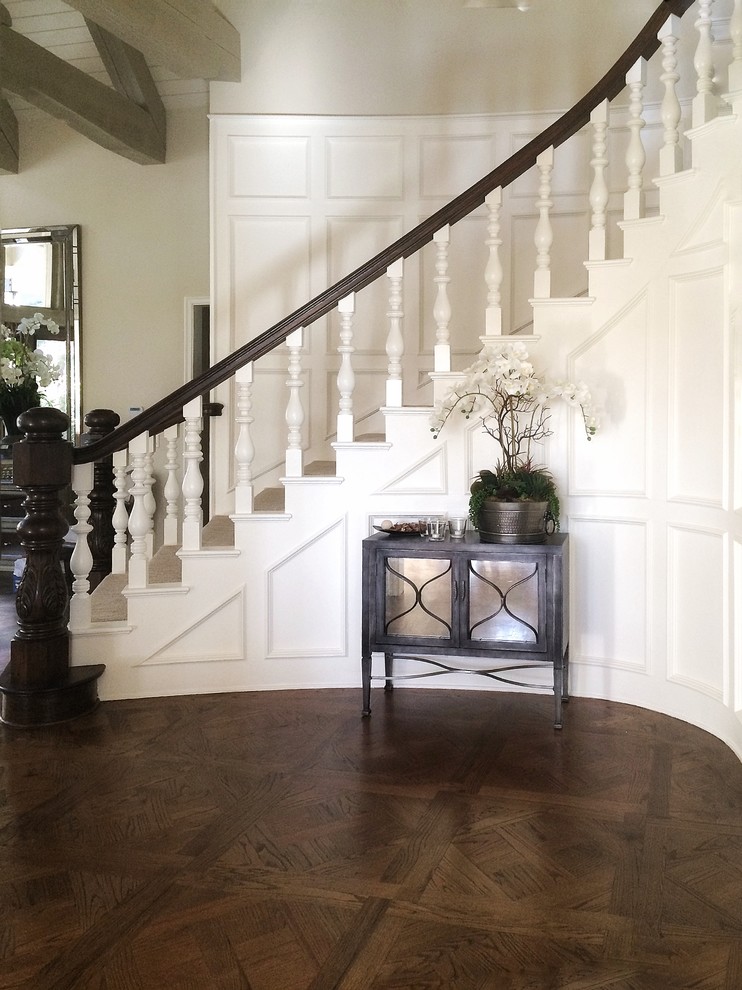 Inspiration for a large country foyer in Los Angeles with white walls, dark hardwood flooring, brown floors, a single front door and a white front door.