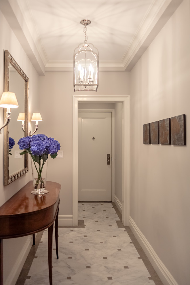Entryway - mid-sized traditional marble floor and multicolored floor entryway idea in New York with beige walls and a white front door