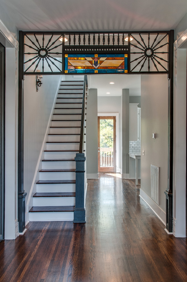 Entryway - small traditional dark wood floor entryway idea in Nashville with beige walls and a dark wood front door