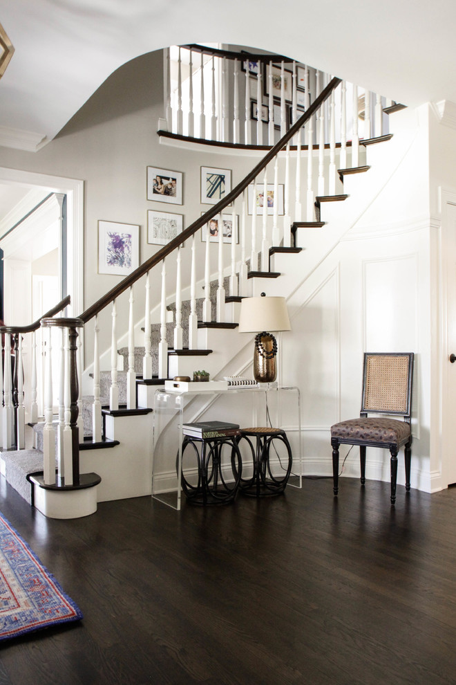This is an example of a large classic foyer in Chicago with grey walls, dark hardwood flooring, a single front door, a dark wood front door and brown floors.