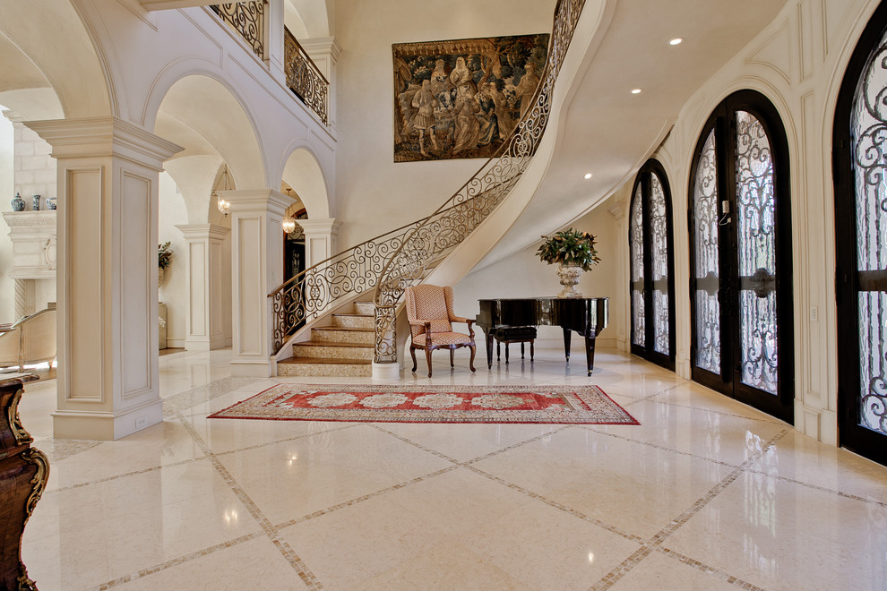 Photo of an expansive mediterranean foyer in Dallas with beige walls, limestone flooring, a double front door, a black front door and beige floors.