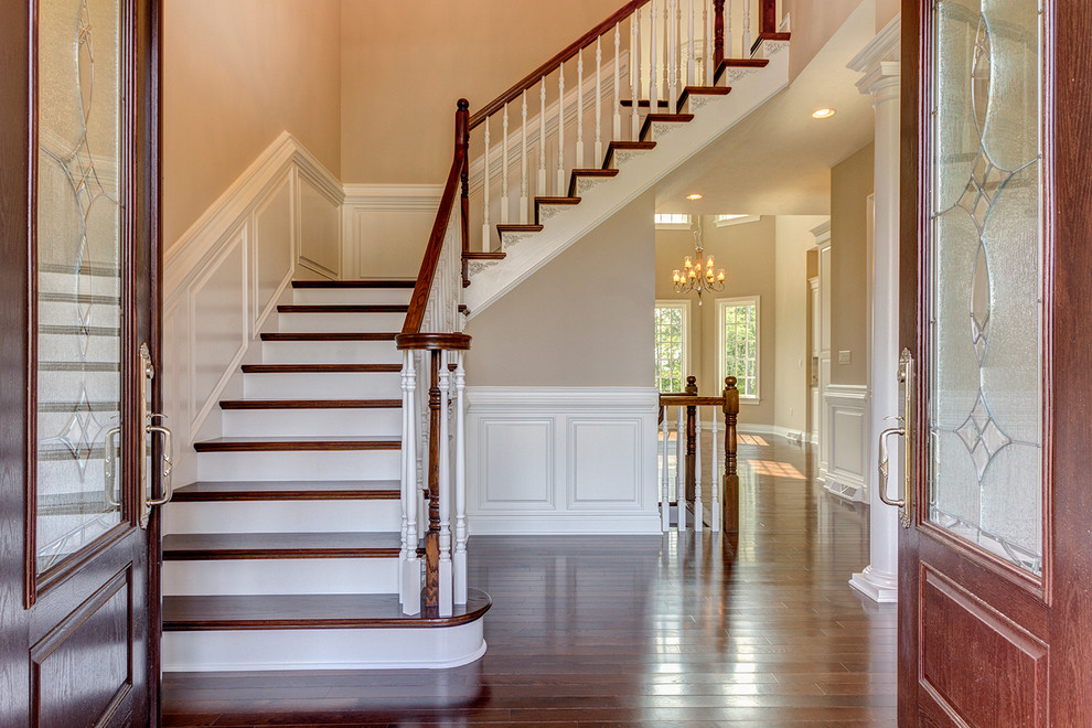 This is an example of a large traditional foyer in Other with beige walls, medium hardwood flooring, a double front door and a medium wood front door.