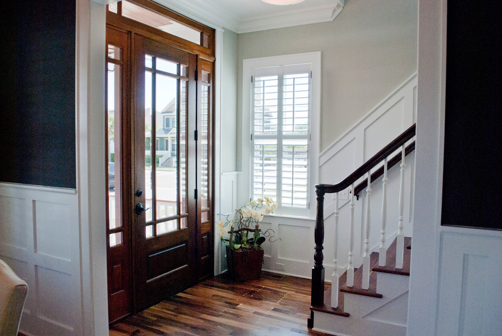 This is an example of a medium sized classic front door in Wilmington with beige walls, medium hardwood flooring, a single front door, a dark wood front door and brown floors.