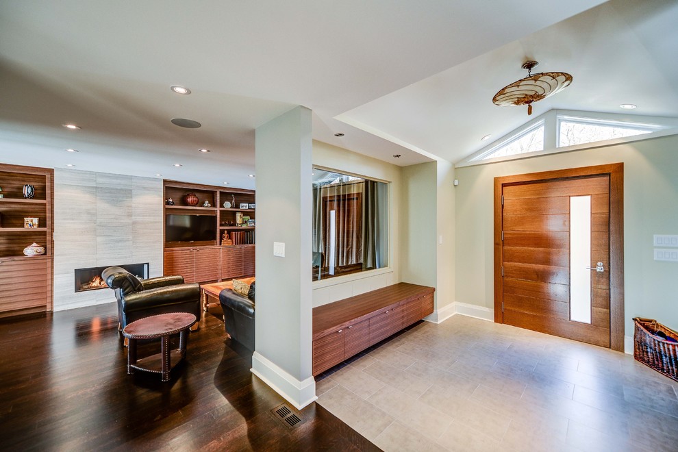 Example of a trendy single front door design in Toronto with a medium wood front door