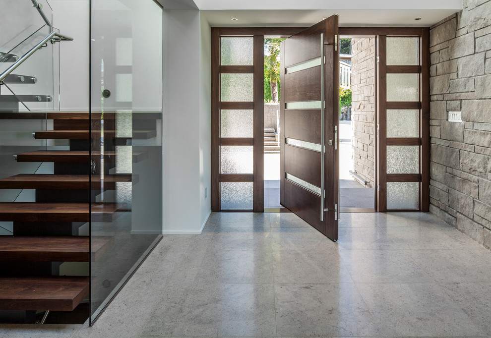 Trendy gray floor pivot front door photo in Vancouver