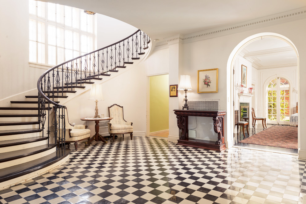 Inspiration for a victorian foyer in New York with white walls and multi-coloured floors.