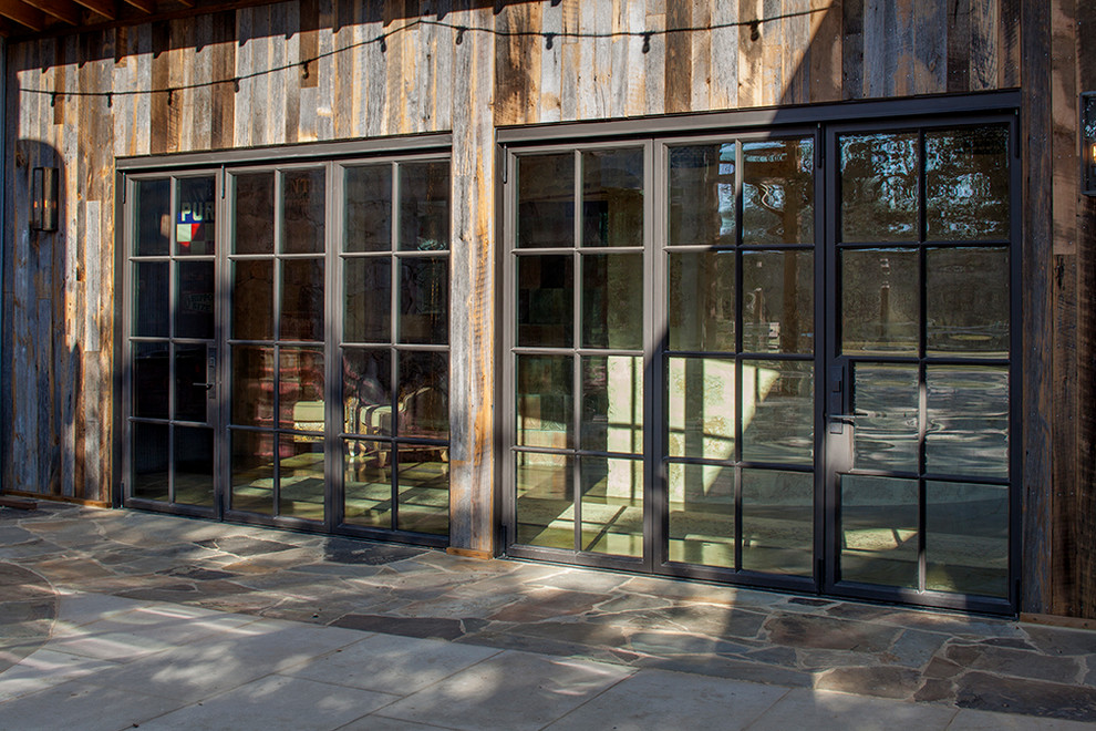 Inspiration for a rustic entryway remodel in Austin with a metal front door