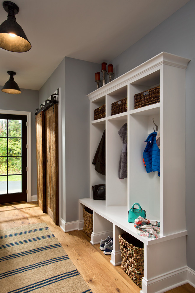 Inspiration for a mid-sized medium tone wood floor entryway remodel in Boston with gray walls and a dark wood front door