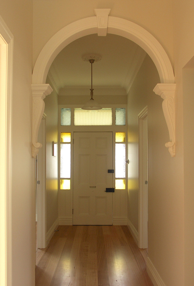 Foto på en mellanstor vintage ingång och ytterdörr, med vita väggar, ljust trägolv, en enkeldörr och en vit dörr