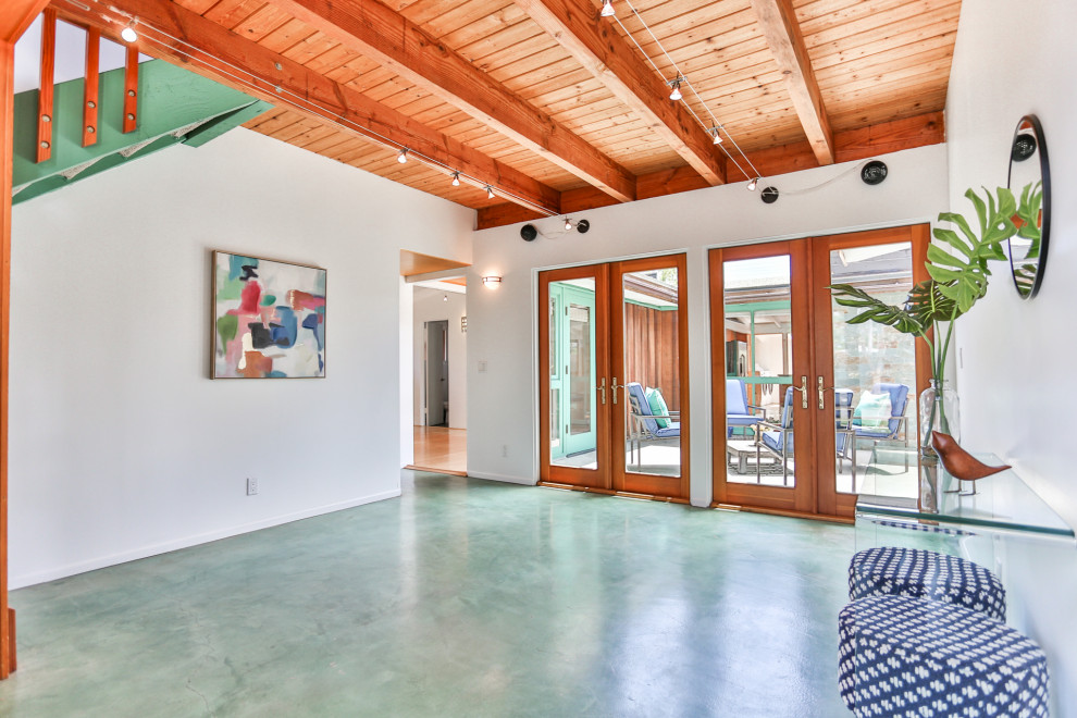 Inspiration for a mid-sized mid-century modern concrete floor and green floor foyer remodel in Orange County