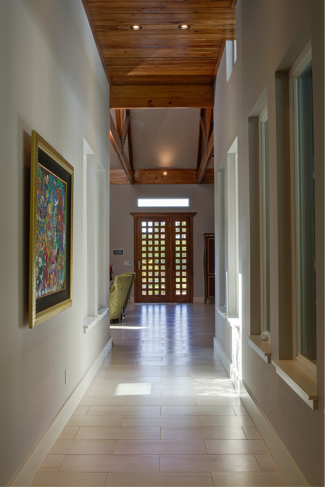 This is an example of a large contemporary front door in Tampa with porcelain flooring, a single front door, grey walls and a medium wood front door.