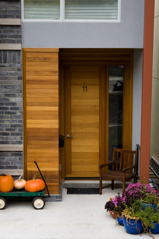 Inspiration for a contemporary entryway remodel in Toronto with a medium wood front door