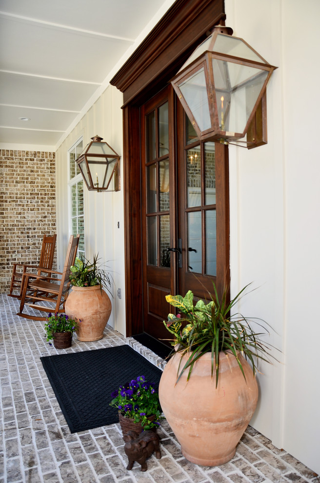 Entryway - traditional entryway idea in Miami with a dark wood front door