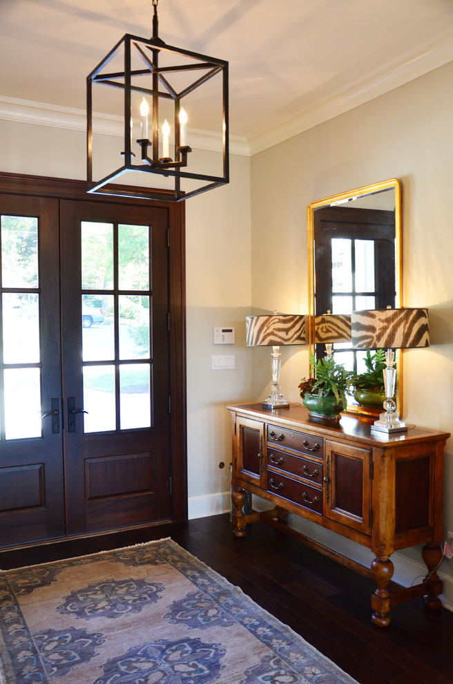 Entryway - traditional entryway idea in Miami with a dark wood front door